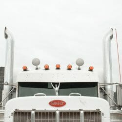 chantal-cadorette-Wty4xhfejaw-unsplash Closeup of the front of a semi truck