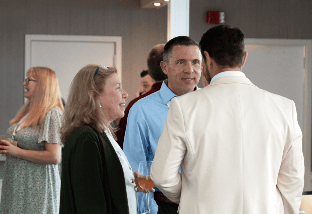 Chris Thacker speaking with attendees at a logistics and transportation networking event