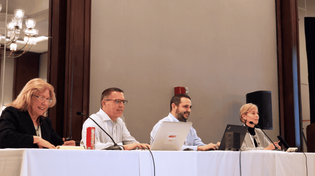 Chris Thacker seated on a panel with other speakers at a trucking and transportation conference