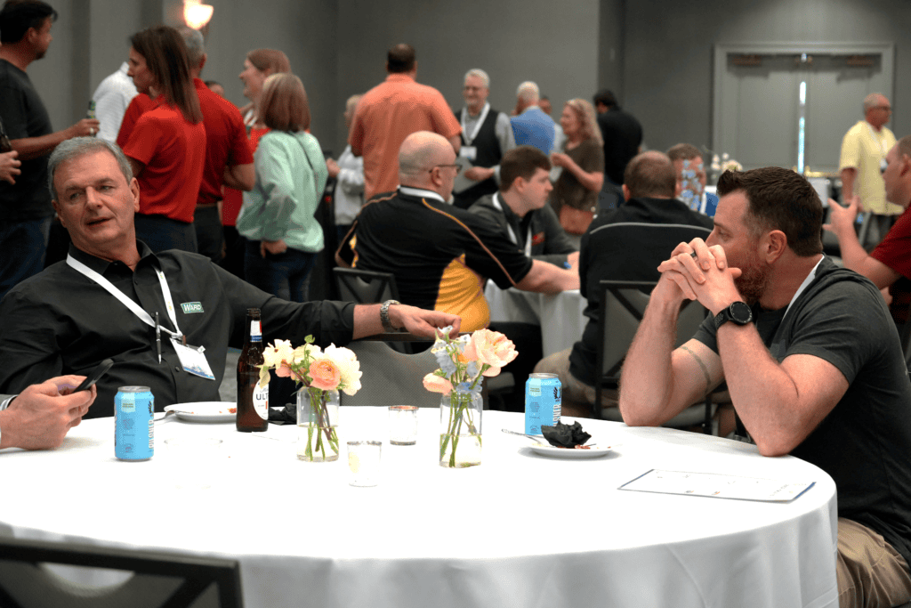 Mike Zupon in conversation with another attendee at an NMFTA event