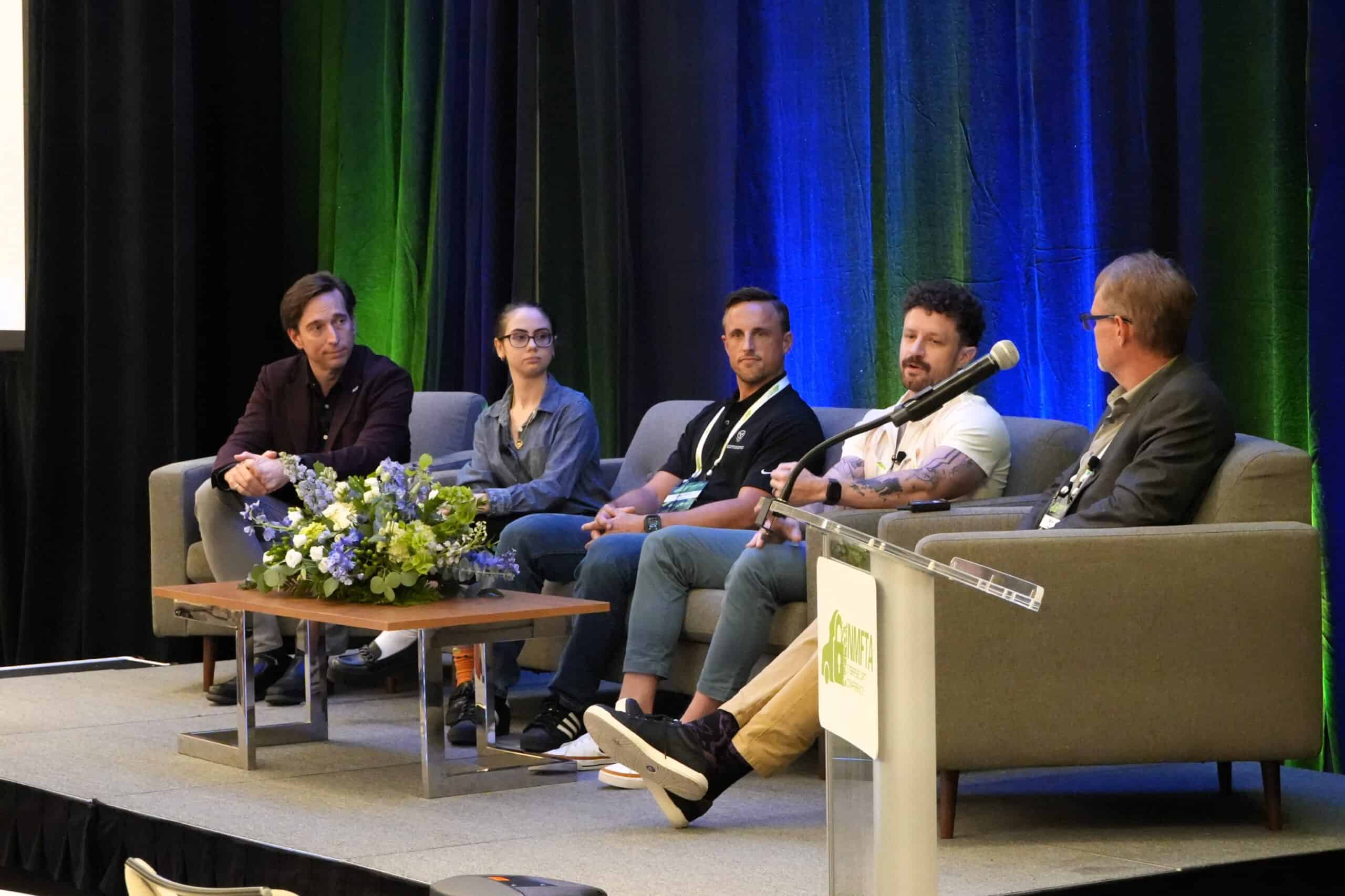 Five transportation and freight technology professionals speaking during a panel discussion at an NMFTA industry conference focused on trucking innovation, cybersecurity, and logistics technology.