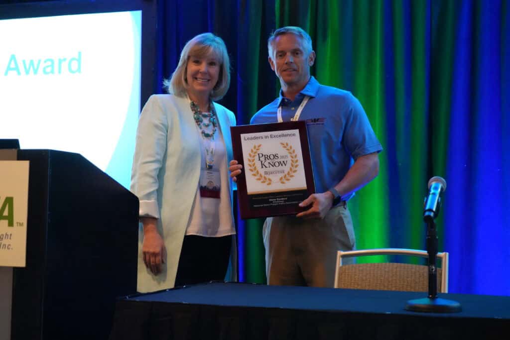 Clete Cordero accepting a 2025 Pros to Know award at an NMFTA event