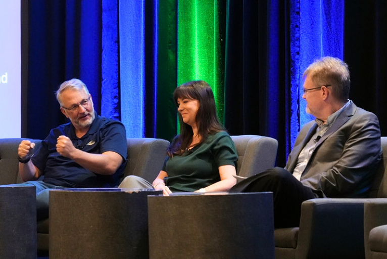 Three industry professionals seated onstage during a panel discussion at the 2026 NMFTA Cybersecurity Conference in Long Beach, California.